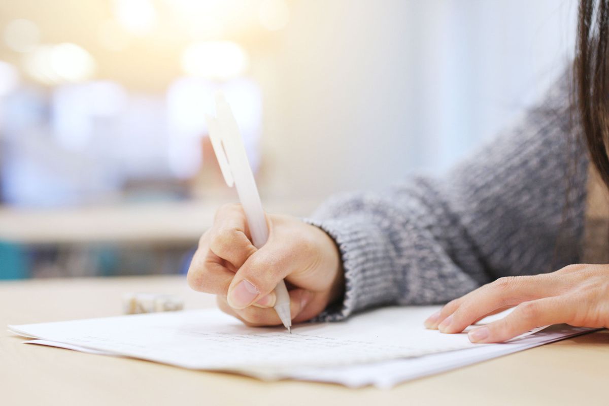 A student working through a math problem on paper