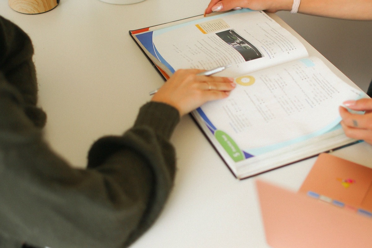 A student working through their notes one-on-one at a desk