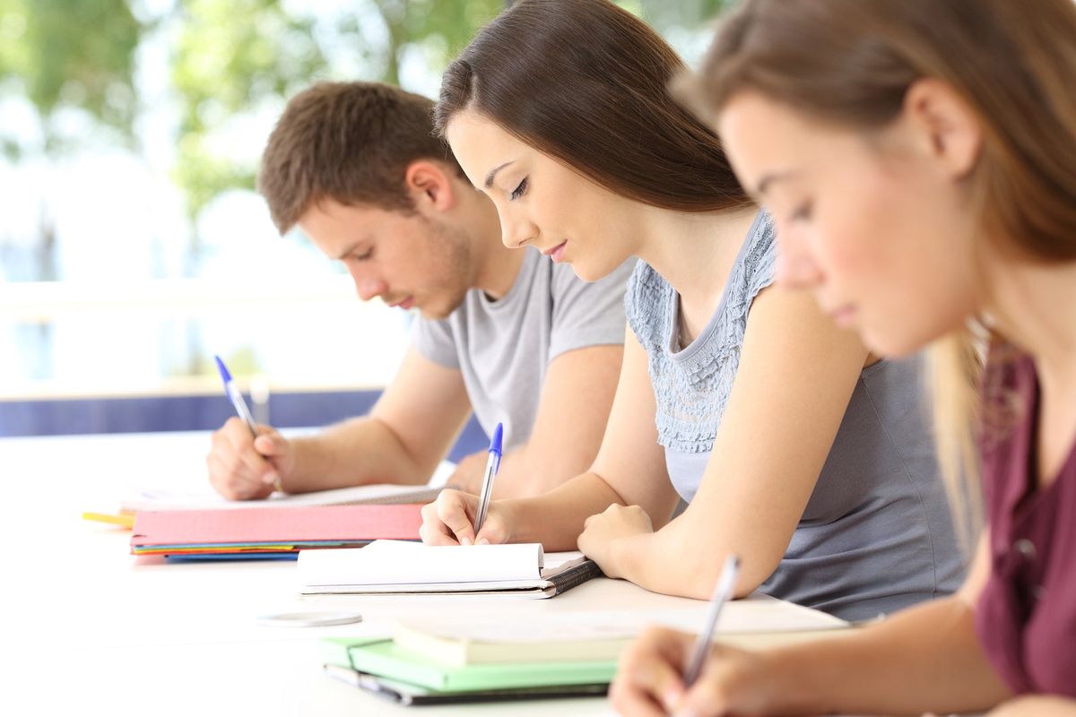 Students working through their notes side by side in class