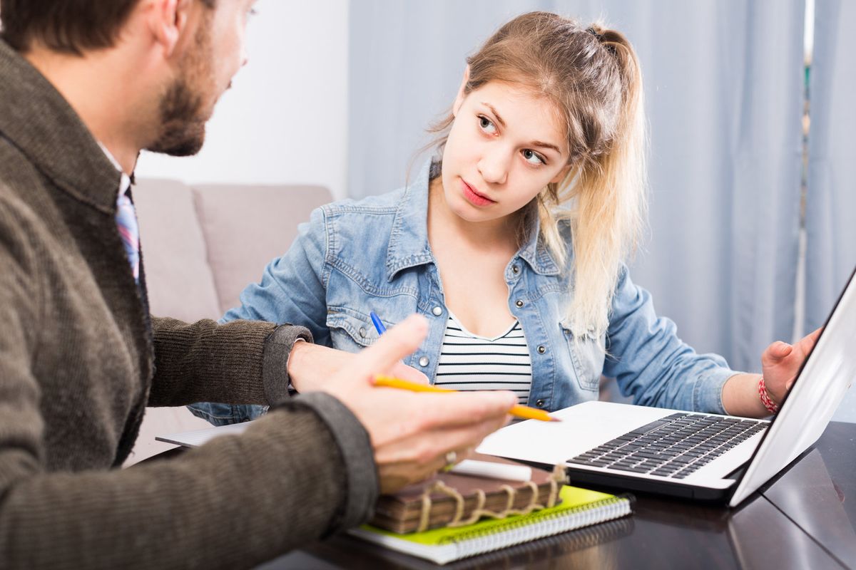 A tutor explaining a problem to a high school student
